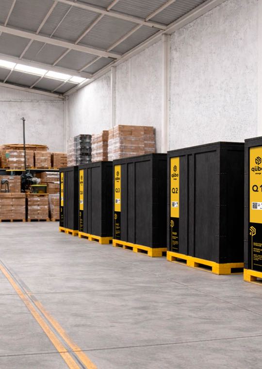 A row of sealed black qübo vaults in the warehouse.